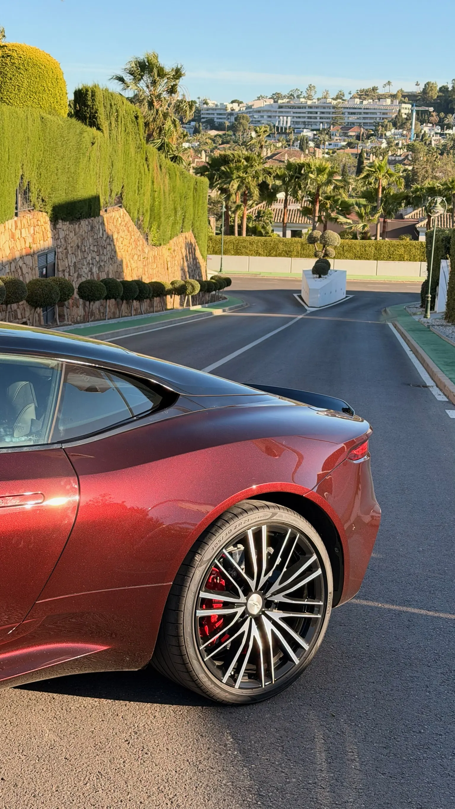 Rear three-quarter view of the Aston Martin DBS Superleggera with 21-inch Y-Spoke wheel, red Brembo caliper and 305/30 ZR21 Pirelli tyres