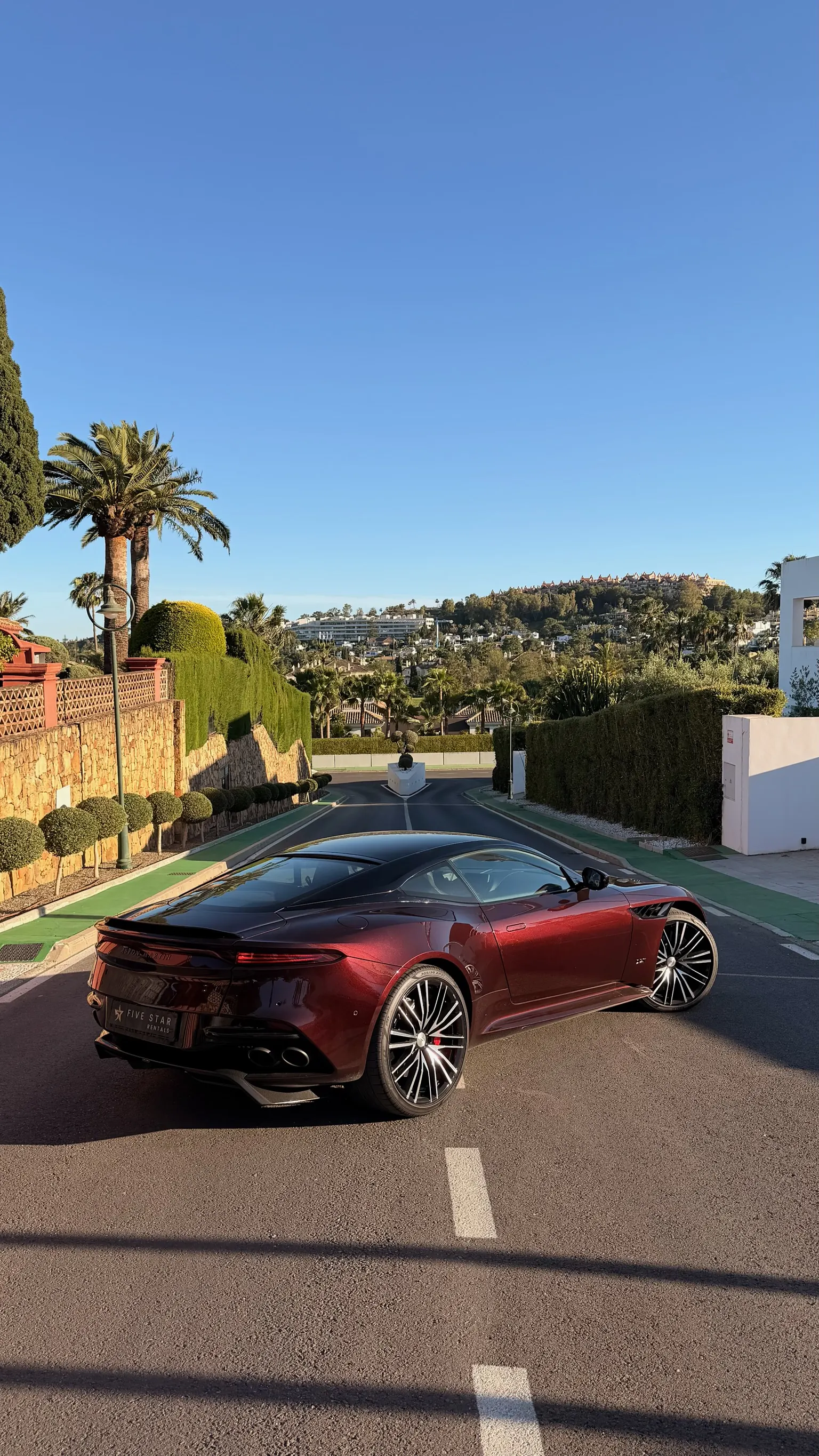 Rear view of the Aston Martin DBS Superleggera with chrome ASTON MARTIN badge, Five Star Rentals plate, dual exhaust and carbon diffuser