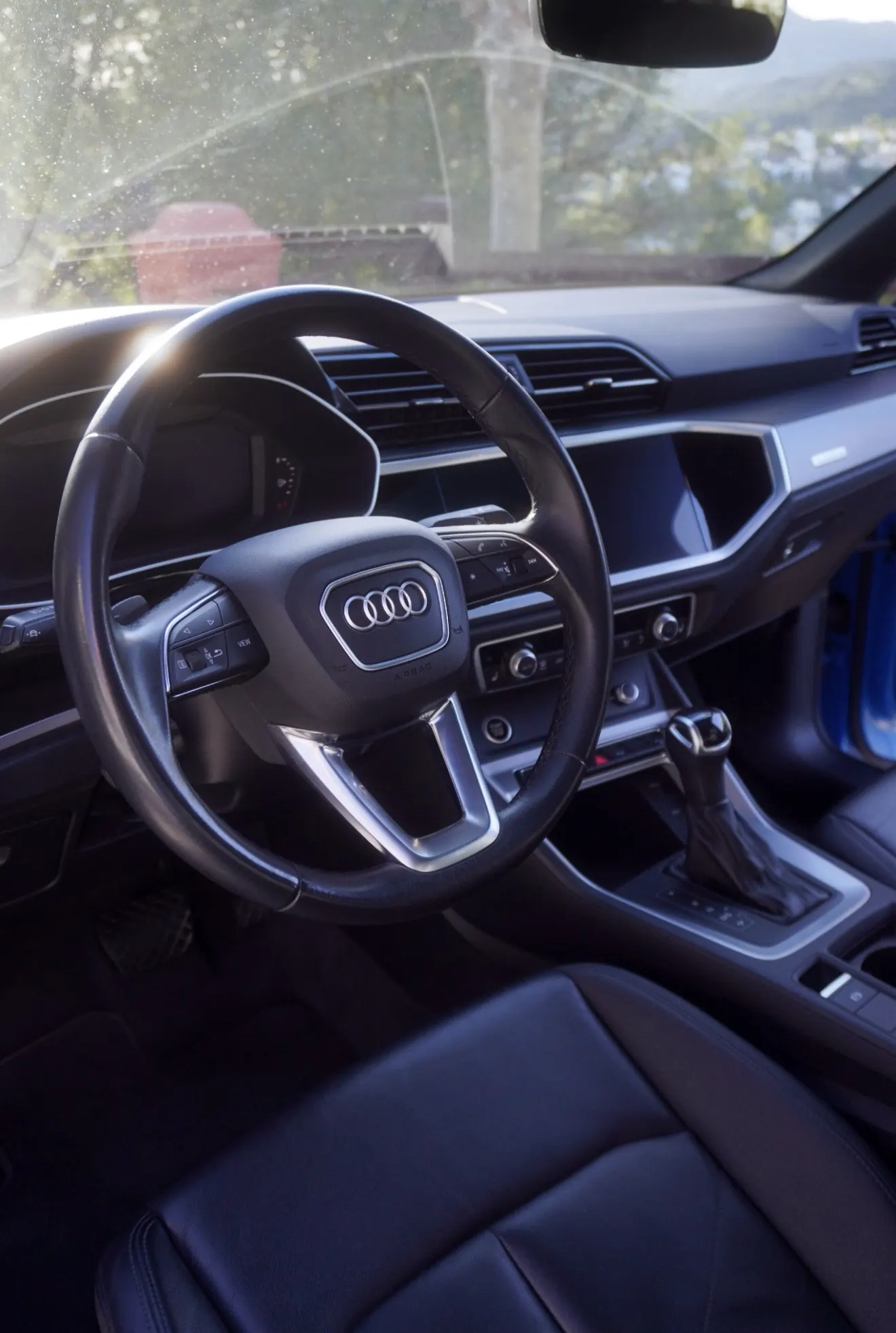 Audi Q3 cockpit with leather steering wheel, vertical MMI touchscreen, Audi virtual cockpit, S tronic DSG shifter and black leather sport seats