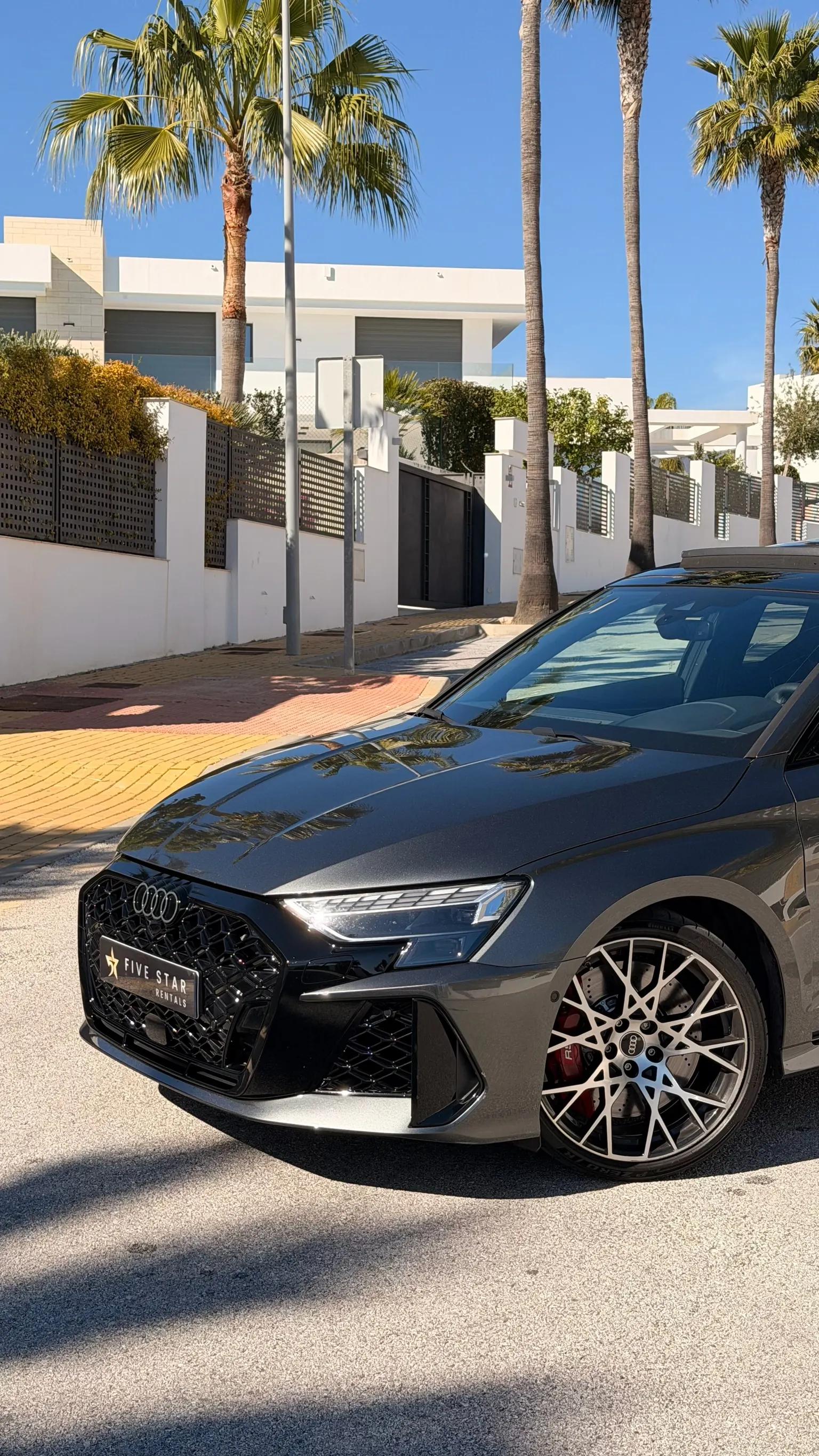 Audi RS3 front detail with black honeycomb Singleframe grille, 19-inch rotor wheel and red brake caliper