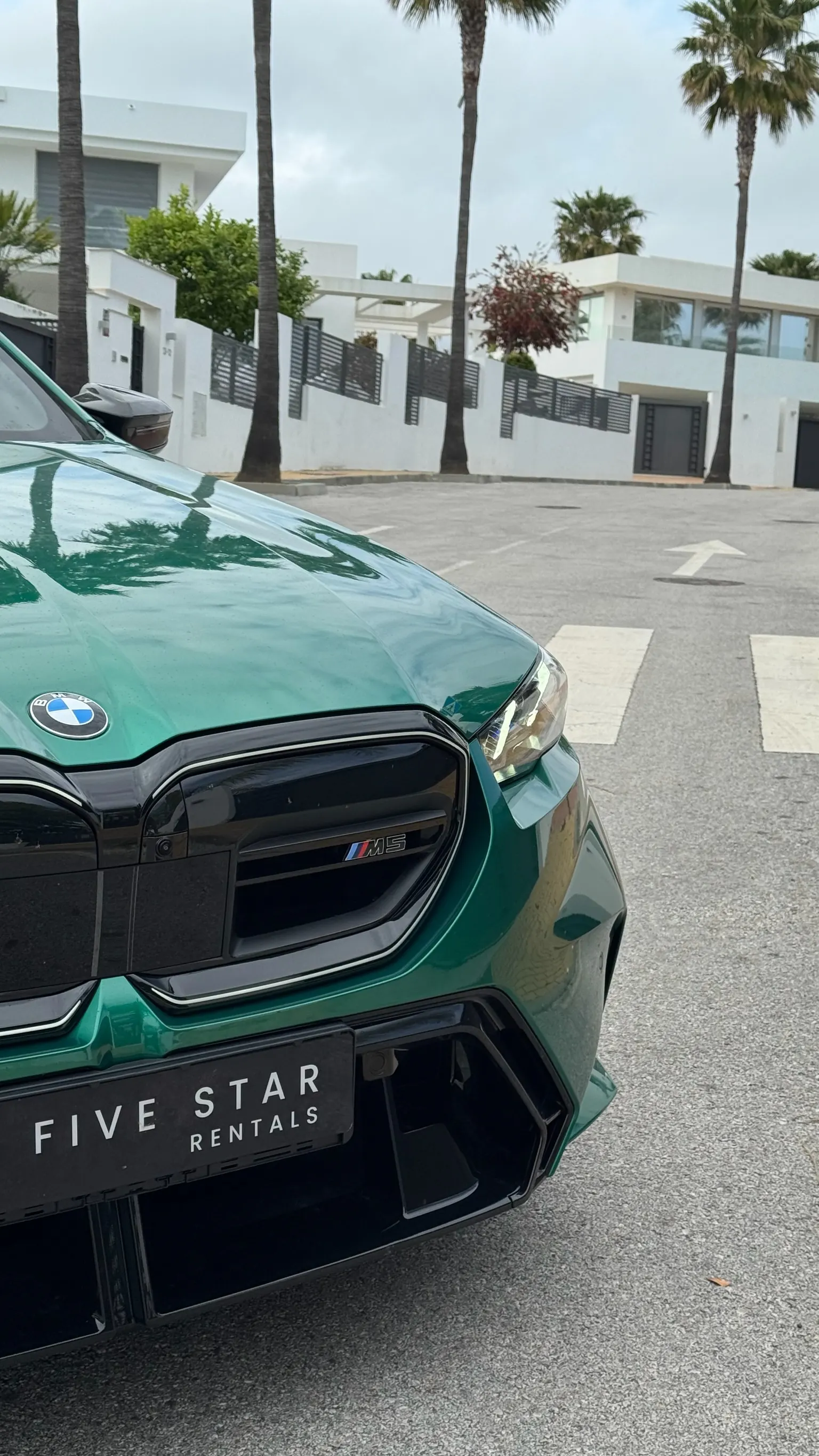 BMW M5 Touring front detail: Iconic Glow grille with M5 badge and Five Star Rentals plate