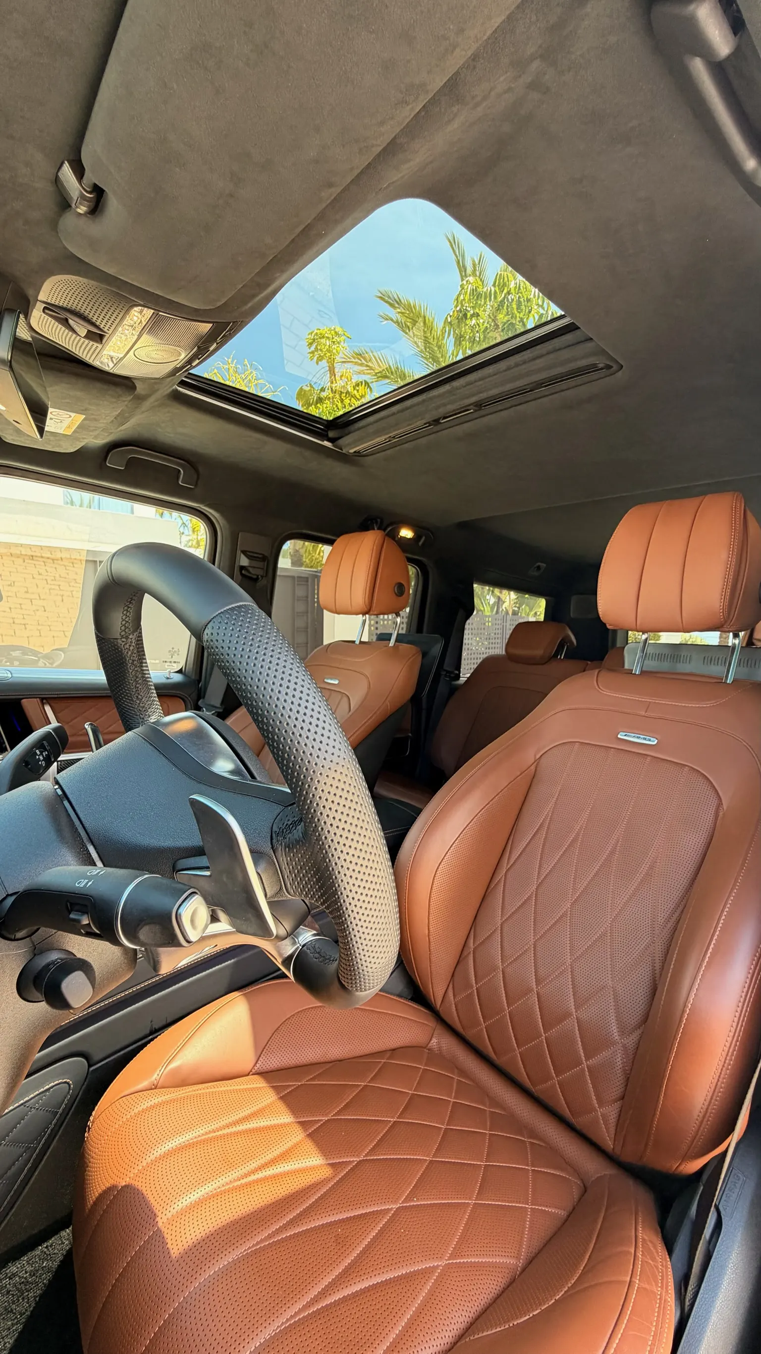 AMG diamond-stitched cognac Nappa leather seats, panoramic sunroof and Alcantara headliner