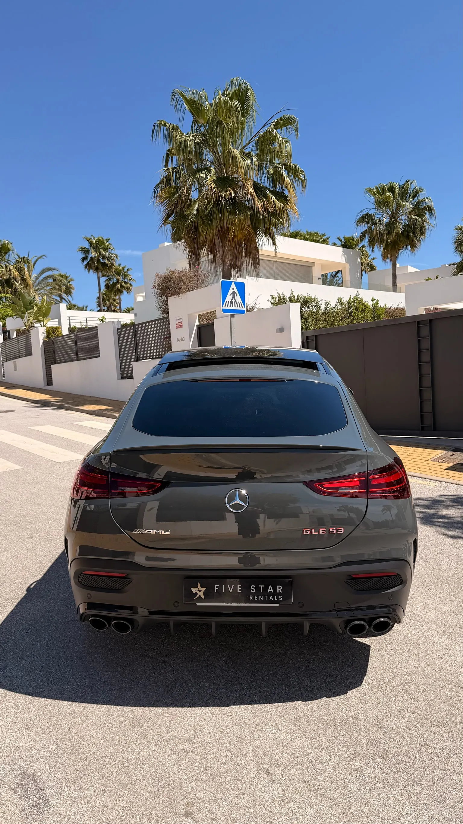 Centered rear view of the Mercedes-AMG GLE 53 Coupé with red AMG GLE 53 badge, black quad exhaust and Five Star Rentals plate