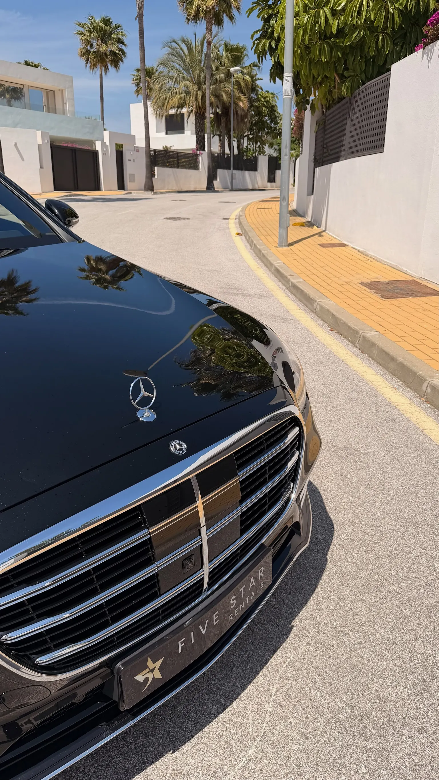 Mercedes-Benz S 580 e front detail with central hood star, chrome vertical-slat grille and Five Star Rentals plate