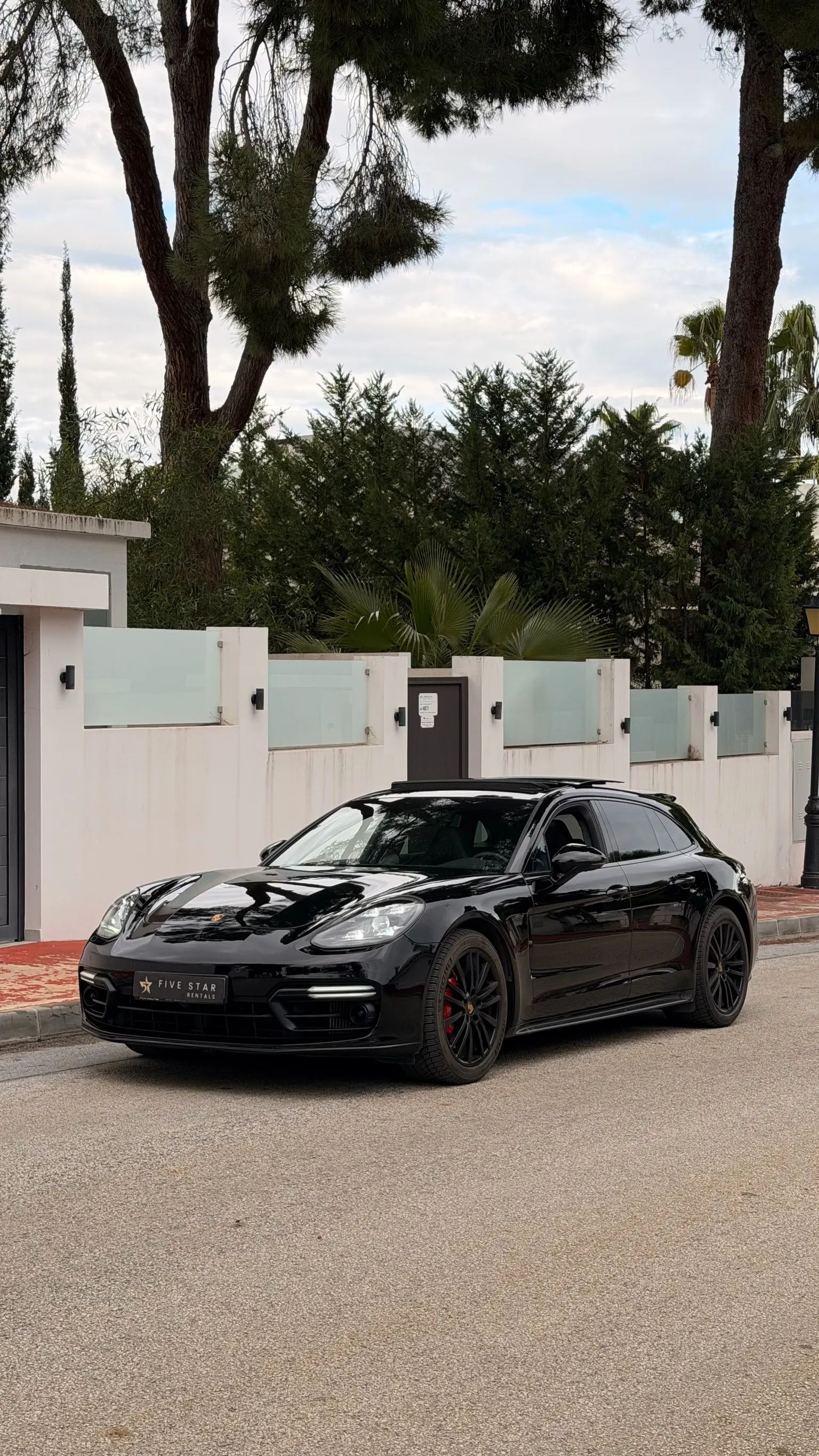 Black Porsche Panamera GTS Sport Turismo, front three-quarter view with Five Star Rentals plate in Marbella